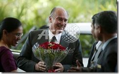 Imam (spirtual leader) of the Shia Imami Ismaili Muslims, the Aga Khan (C) is welcomed at the Taj Residency