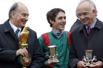 Paris October 5, 2008: (L-R) His Highness Prince Karim Aga Khan IV owner of French horse Zarkava, Belgian jockey Christophe Soumillon and his trainer Alain de Royer Dupre pose with winning trophies after capturing the 87th Arc de Triomphe horsing race, the world's richest race on turf, at Longchamp Racecourse near Paris. Image credit: Reuters