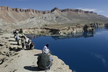 In this photo taken Tuesday, June 16, 2009, visitors enjoy the view of a lake in Band-e-Amir, in the central Afghanistan's province of Bamiyan. The six azure lakes in Band-e-Amir are Afghanistan's first national park. In an attempt to return one small part of the country to normalcy government officials and international donors are promoting tourism to attract visitors to the Bamiyan area. (AP Photo/Rahmat Gul)