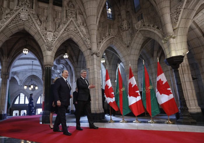 Canada's PM Harper walks with the Aga Khan in the Rotunda on Parliament Hill in Ottawa