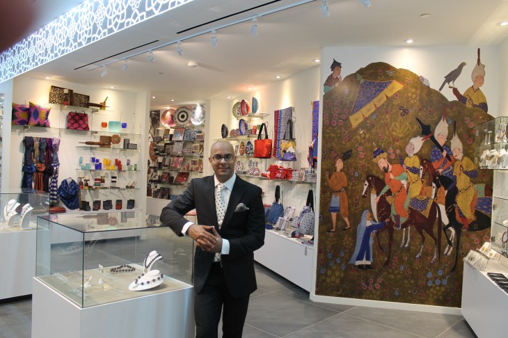 AKM Gift Shop - Shoheb Gwaduri, Aga Khan Museum's Manager of Business Development standing at the entrance of the Gift Shop with products from 15 different countries.