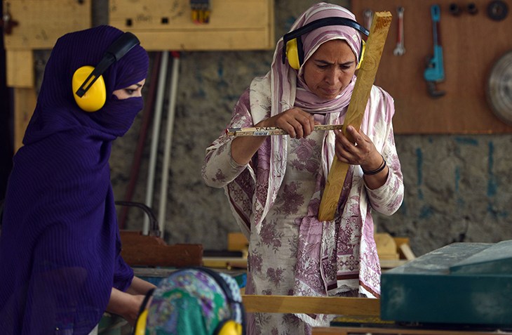 High in Pakistan’s mountains, women break taboos: Carpenters work at their woodshop in Altit village in northern Hunza valley. AFP Photo