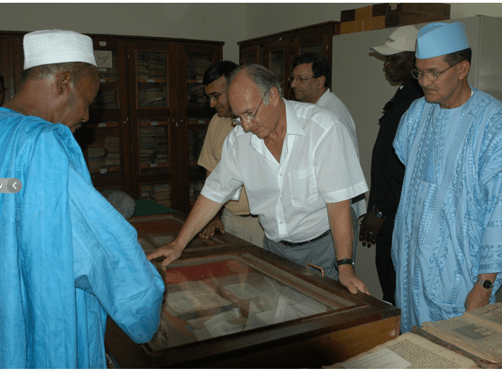 From Ismailimail Archives: Timbuktu, Mali, 10 October 2003. His Highness the Aga Khan (centre) and Prime Minister Ahmed Mohamed Ag Hamani (right) examining ancient manuscripts at the Ahmed Baba Centre in Timbuktu, Mali. - Photo AKDNGary Otte