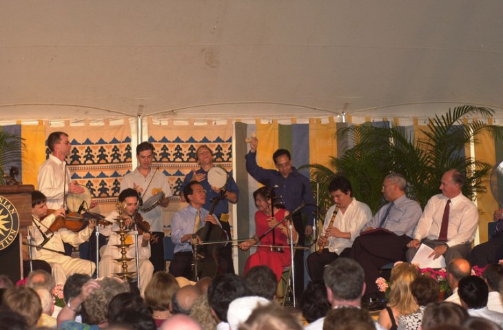 From the Ismailimail archives 2002-06-26: Yo-Yo Ma and members of the Silk Road Ensemble performing at the opening ceremony of the Smithsonian Folklife Festival. Secretary of State Colin Powell and His Highness the Aga Khan are seated at right. - Photo: AKDN/Zahur Ramji