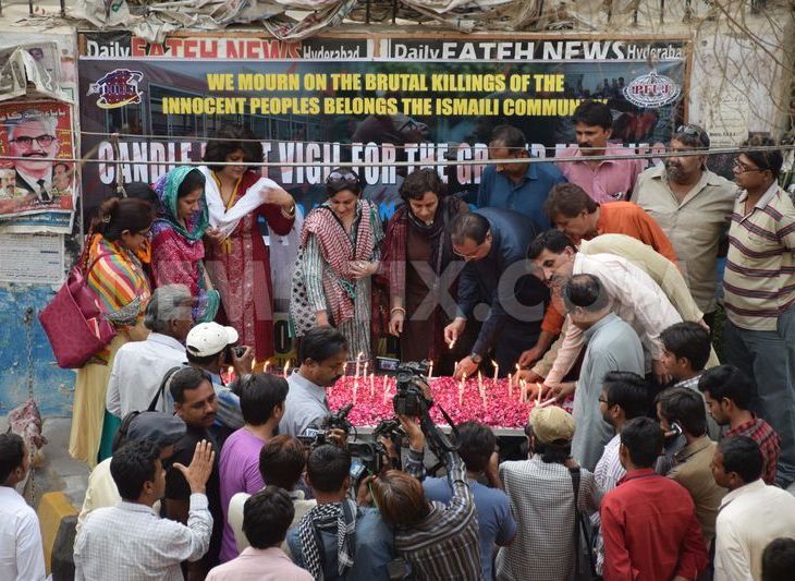 Members of Hyderabad union of journalist light candles during vigil for the 48 people killed in a bus attack in Karachi's Ismaili community. (Image via Demotix)
