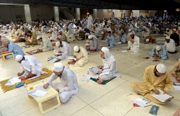 Pakistani seminary students take their first semester exam at the Islamic Jamia Binoria seminary in Karachi. More than 3,300 students took their examinations at the seminary where hundreds of Pakistanis and foreigners study. (AFP PHOTO/ Rizwan TABASSUM via the News on Sunday)