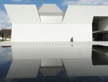 The Aga Khan Museum is reflected in pool.