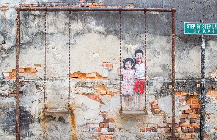 Realistic Children on the Swing at Step by Step Lane in George Town Malaysia. The Aga Khan Trust is once again working with the state government and Think City Sdn Bhd to provide technical assistance in restoration and preservation of the heritage site. (Image via The Rakyat Post)