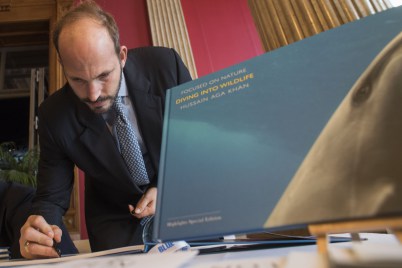 Monaco, November 7-9, 2015: Prince Hussain Aga Khan signing his book, Diving into the Wildlife at the BLUE Ocean Film Festival & Conservation Summit. (Image credit: Monaco Reporter)