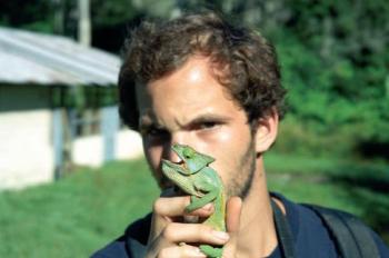 Prince Hussain Aga Khan holding a chameleon in Madagascar , 1997 (image credit: © Julian Cook) in book Animal Voyage