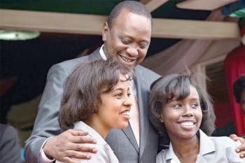 The Aga Khan Academy, Mombasa students Magdalena Gakuo and Sumera Yego with his Excellency President Uhuru Kenyatta, during the award ceremony. (Image via Coastweek)