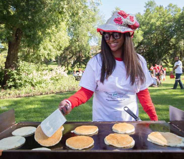 Serena Hemraj flips pancakes for the pancake breakfast, hosted by the Aga Khan Council of Edmonton, during Canada Day festivities at the Alberta Legislature in Edmonton July 1, 2016. (Image credit: AMBER BRACKEN/EDMONTON JOURNAL)
