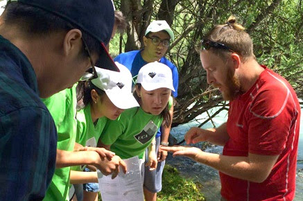 In the environmental monitoring workshop, bio-indicator expert Amadeus DeKastle identifies local organisms indicating the health of the Chong Ak Su river ecosystem.