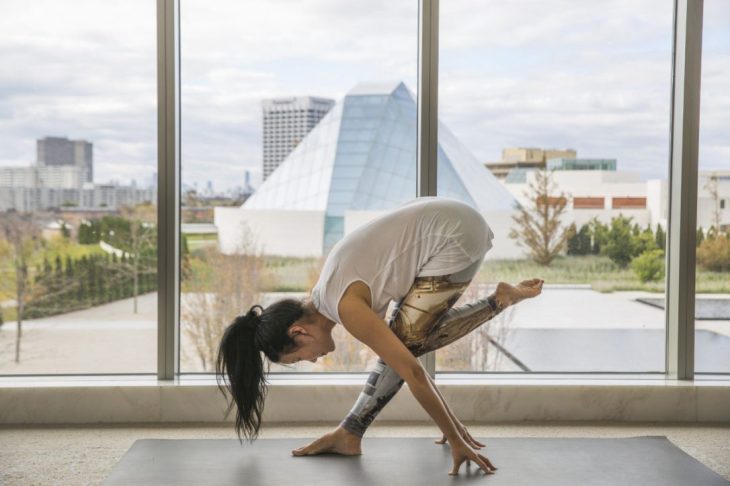Yoga instructor YuMee Chung demonstrates a daring Pyramid Pose at the Aga Khan Museum, with the Ismaili Centre, Toronto in the background. (Image credit: Anne-Marie Jackson)