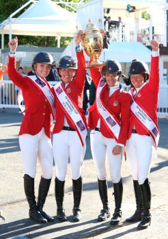 The all-female American team, from left to right: Lillie Keenan, Lauren Hough and Laura Kraut holding the Aga Khan Trophy, and Elizabeth Madden celebrate after winning the nations cup at the Dublin Horse Show in the RDS. (Image credit: Damien Eagers)