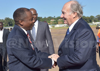 Attorney General William Byaruhanga receives the Aga Khan at Entebbe Airport yesterday evening. (Credit: William Rujuta)