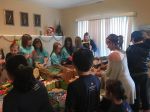 Local girl, volunteers pack bags for homeless children