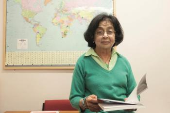 Amina delivering a talk on her international trials to reduce treatment duration for tuberculosis. The world map shows the centres, Asia, Africa and Latin America where these trials are conducted