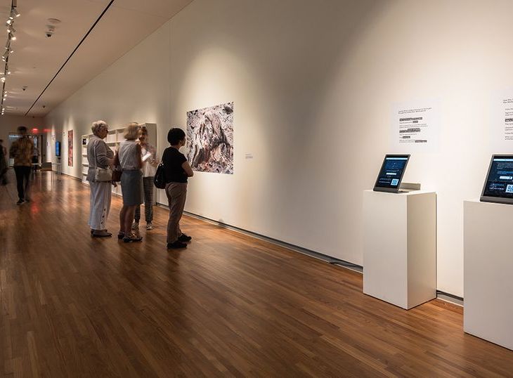 Visitors to the Toronto show look at a photograph of the burned-out Baghdad Library in the aftermath of the 2003 US military campaign Photo: Aly Manji