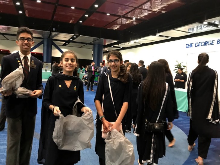 Young volunteers welcoming the Jamat in the hall.