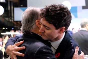 Paris, France. November 11, 2018: His Highness Prince Karim Aga Khan IV, and Justin Trudeau, Prime Minister of Canada, are seen in a warm embrace at the 2018 Paris Peace Forum Opening Plenary in the Agora. Image credit: Marion Dubier Clarck